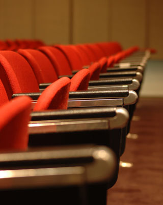 Red chairs in a lecture theatre