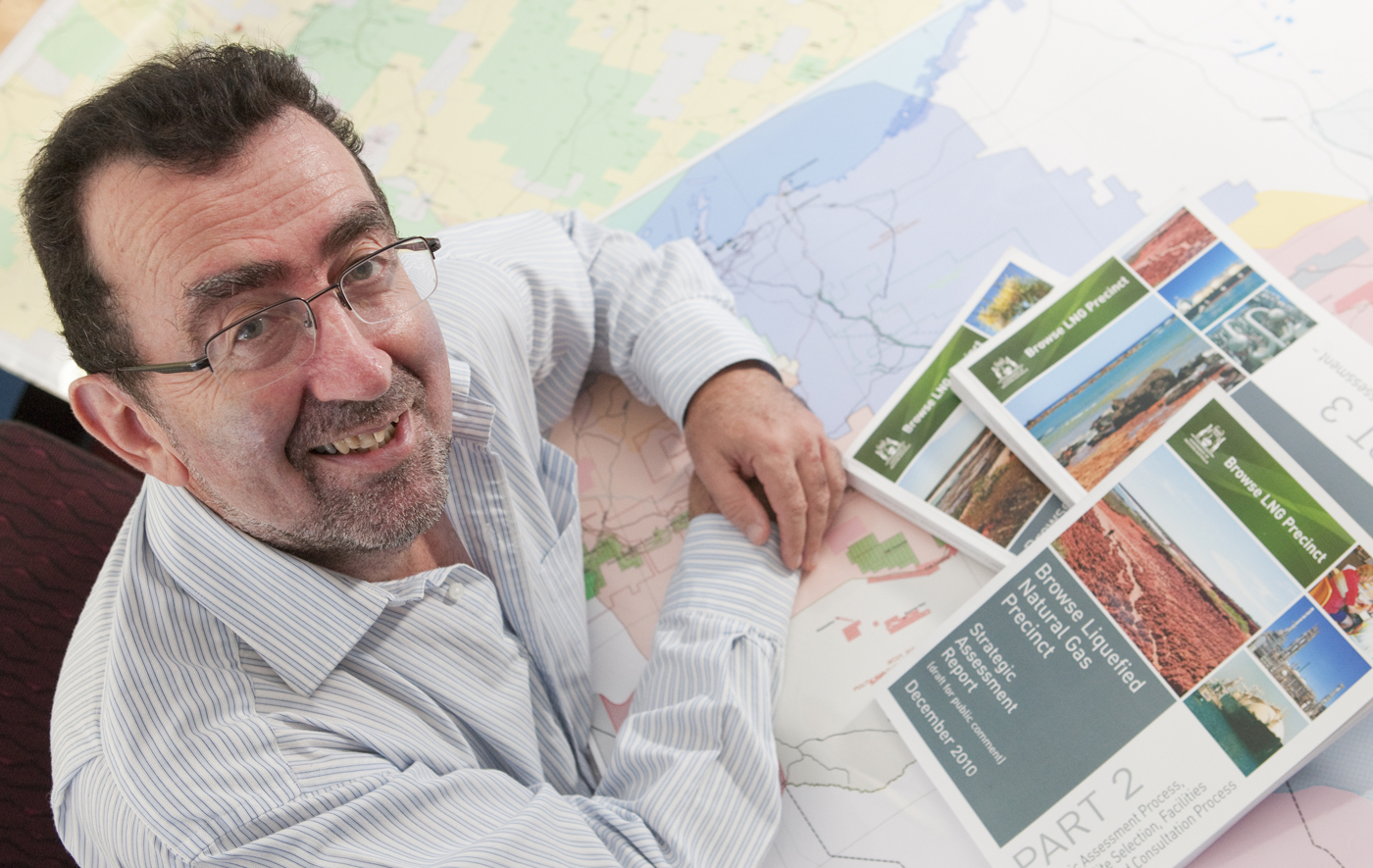 Professor Ciaran O'Faircheallaigh, Griffith University, looks up from brochures and maps.