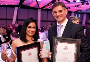 Greg Story and Monique Jeremiah each holding an award and framed certificate at Griffith Business School gala night.