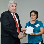 Joyce Wang accepts her award from Professor Paul Mazerolle.