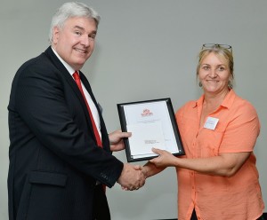 Tracey McCann receives her award from Paul Mazerolle