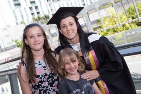 Jill Guljas in graduation outfit with daughters.