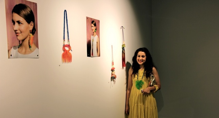 Bianca Mavrick at the 2013 Jewellery and Small Objects graduate exhibition with a display of her work. Image by Laura Burstow.