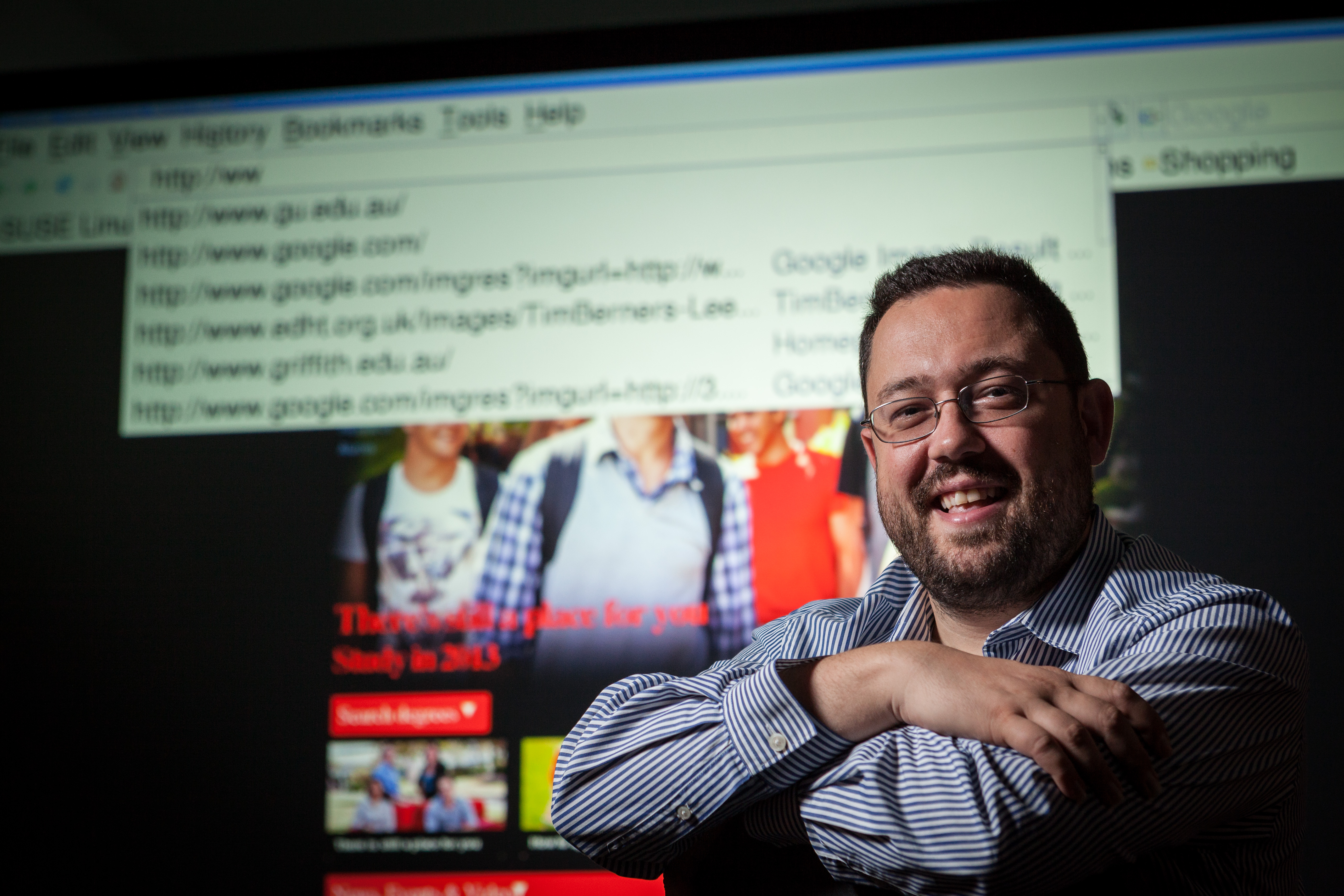 Professor Michael Blumenstein smiling in front of projection screen