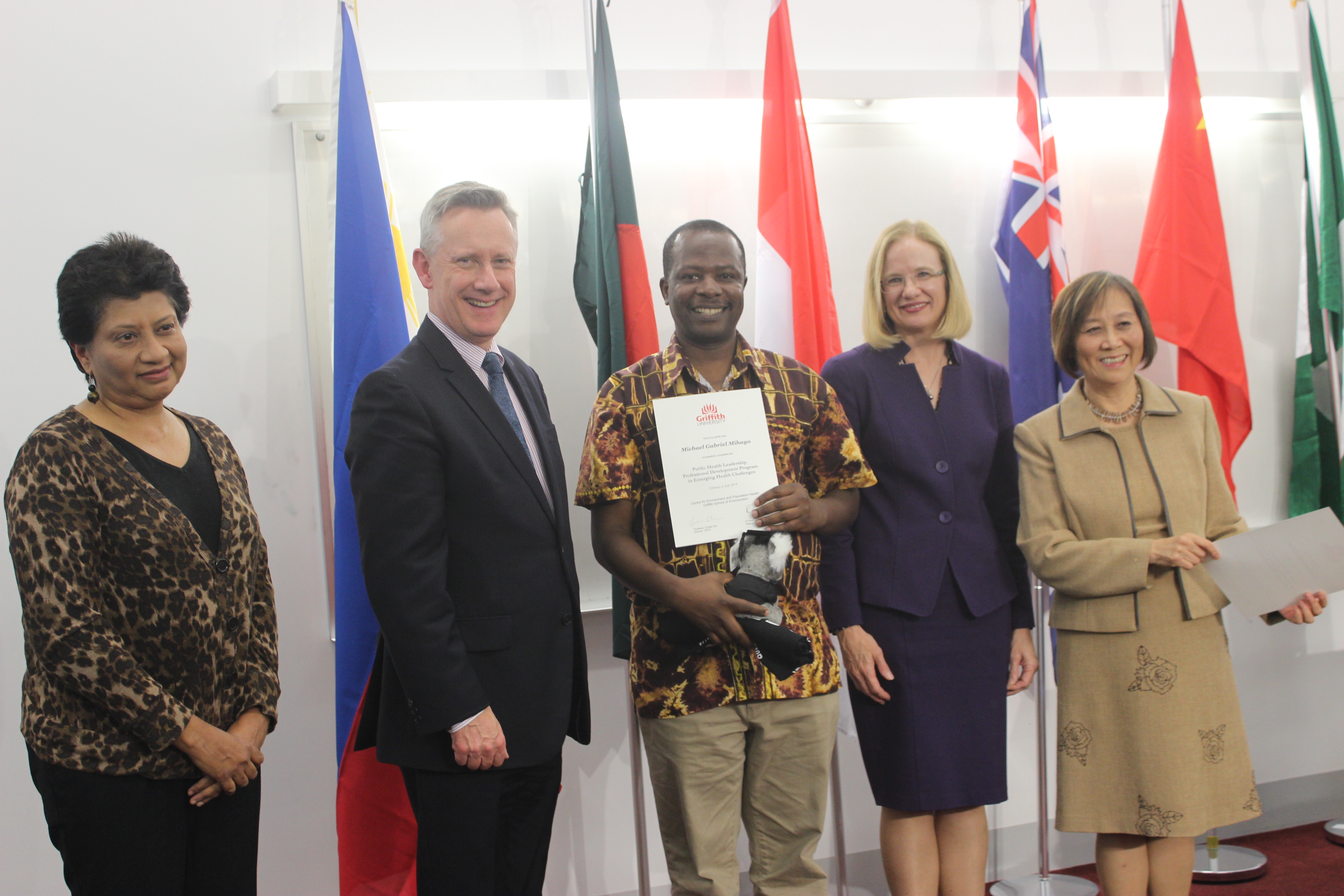 Mr Michael Mihayo of Tanzania receives his completion certificate from Academic Provost Professor Adam Shoemaker and Griffith senior staff