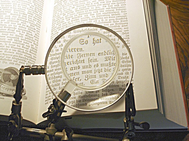 Picture of book and magnifying glass