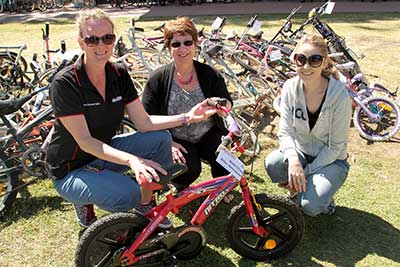 Susie Head, Kay Ollett and Tara Wallis with one of the donated bicycles