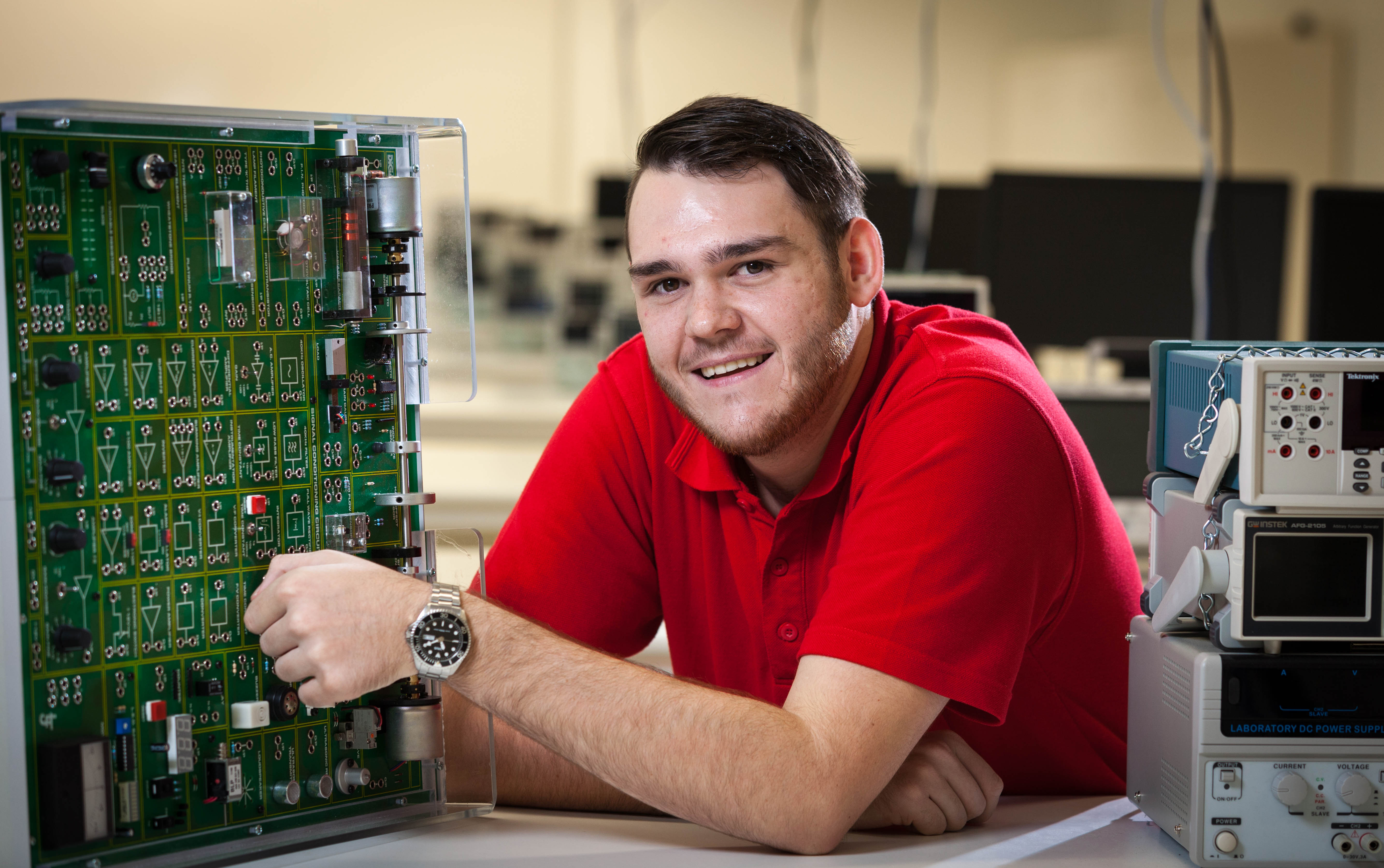 Bachelor of Electronic and Biomedical Engineering student Zachery Quince working with circuit board