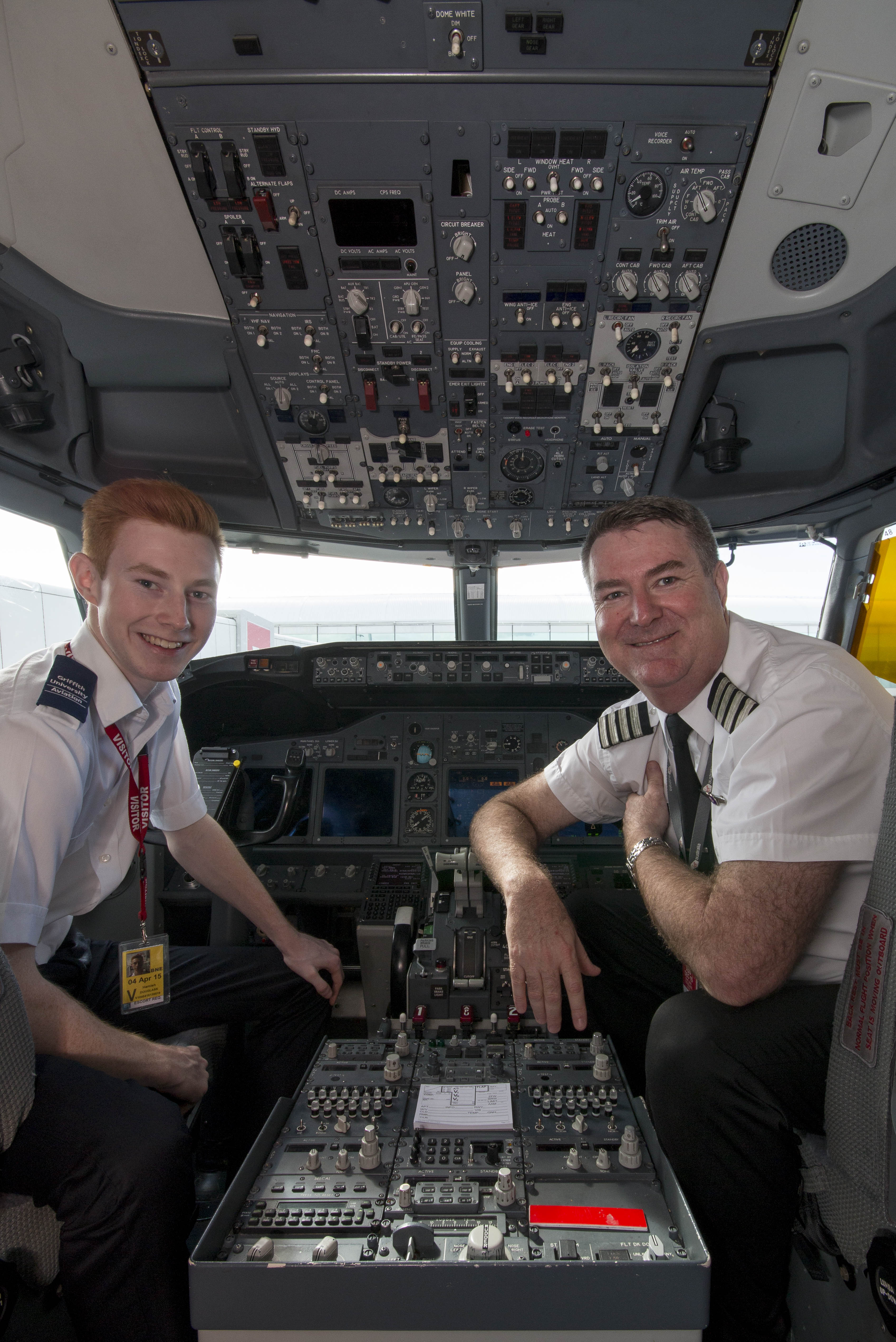 Griffith University students -and father and son - Brett (right) and Hamish (left) Douglass in a Virgin Australia plane at Brisbane Airport.