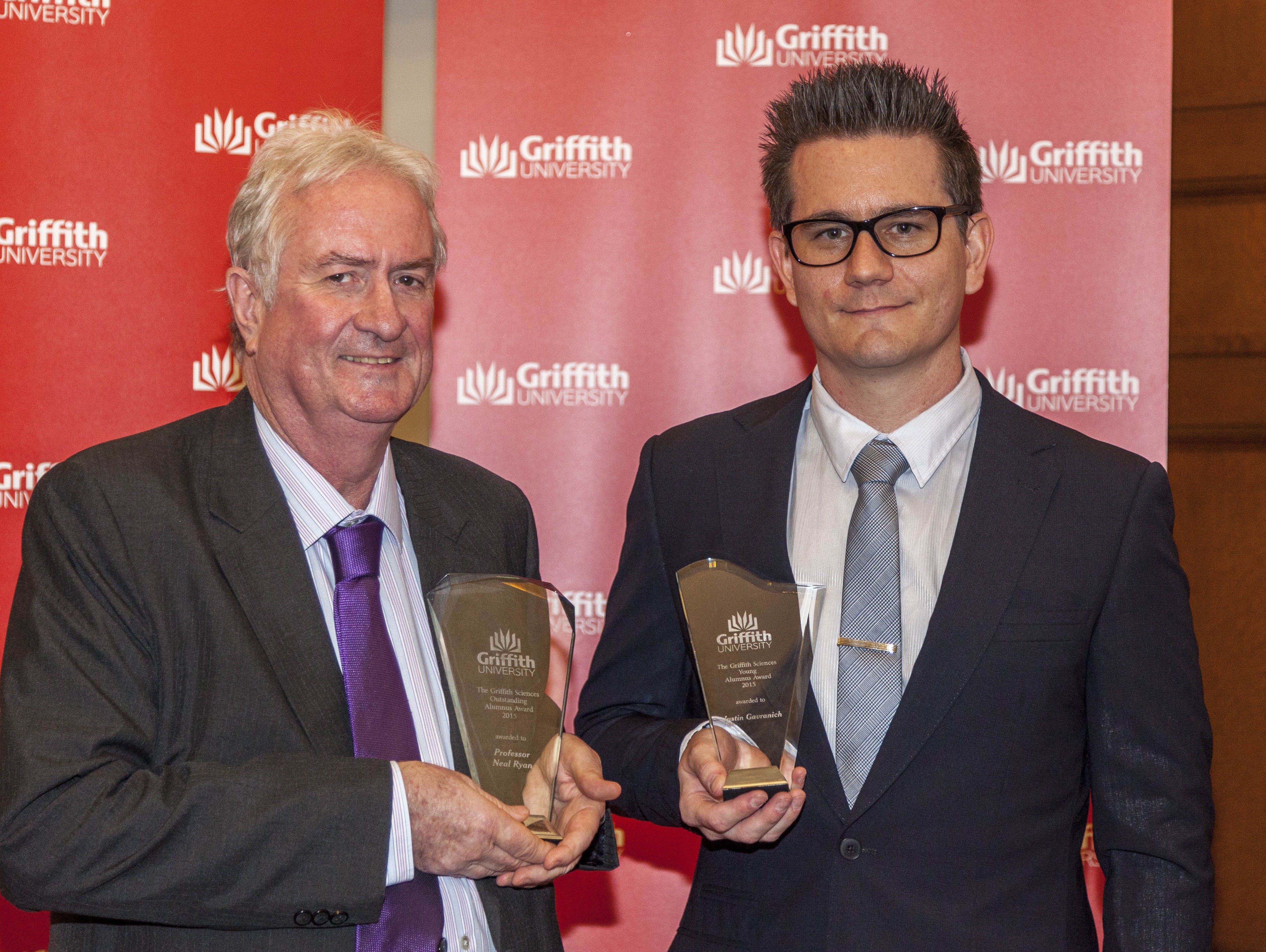 Holding trophies, 2015 Griffith Sciences Alumnus of the Year, Professor Neal Ryan, and Young Alumnus of the Year, Mr Justin Gavranich