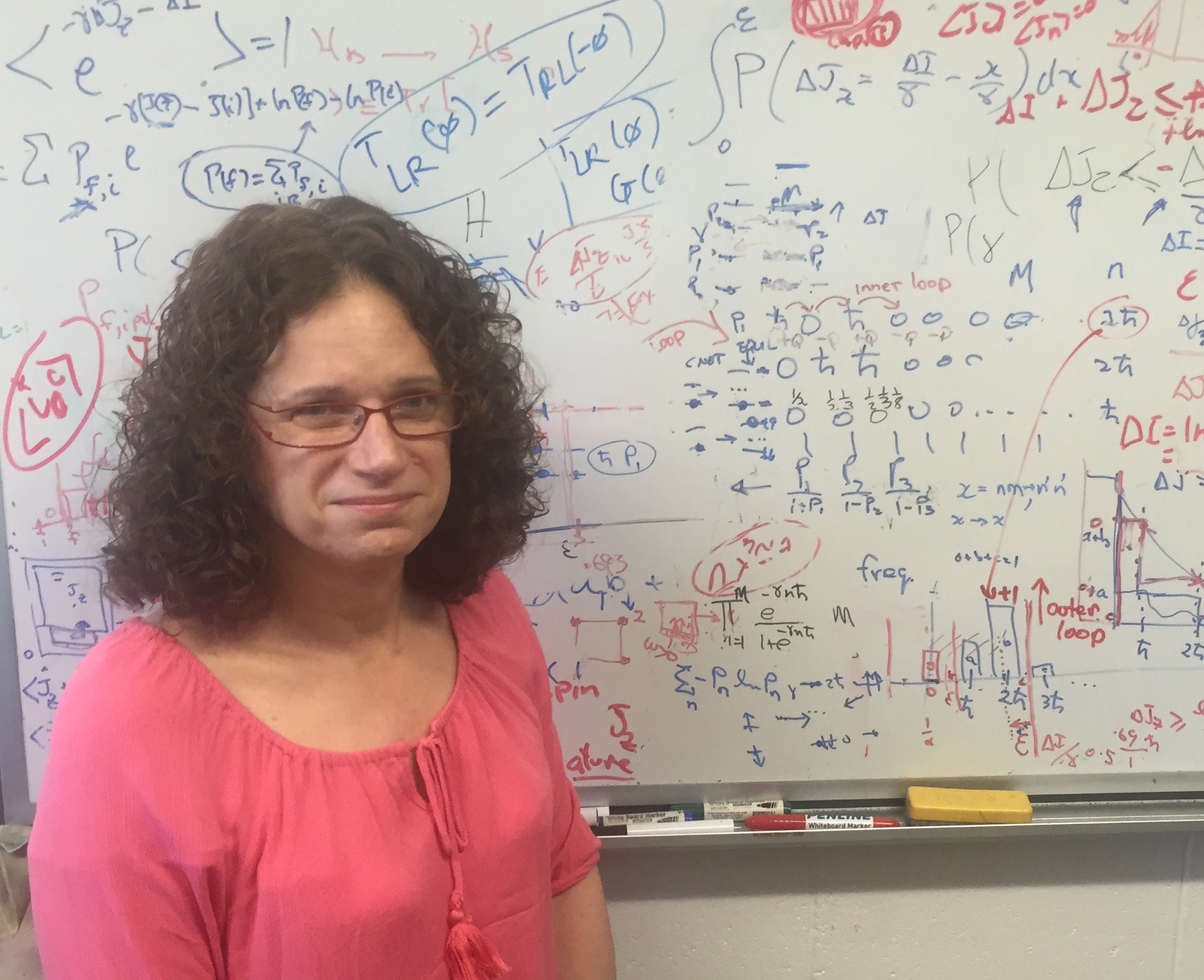 Associate Professor Joan Vaccaro, from Griffith's Centre for Quantum Dynamics, standing in front of a whiteboard covered in equations
