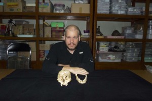 Ass/Prof Maxime Aubert with the skull of the Homo floresiensis holotype skeleton (LB1). Aubert conducted Uranium-series dating of one of the bones from this skeleton, and bones from other 'hobbit' individuals from Liang Bua, to determine their age.
