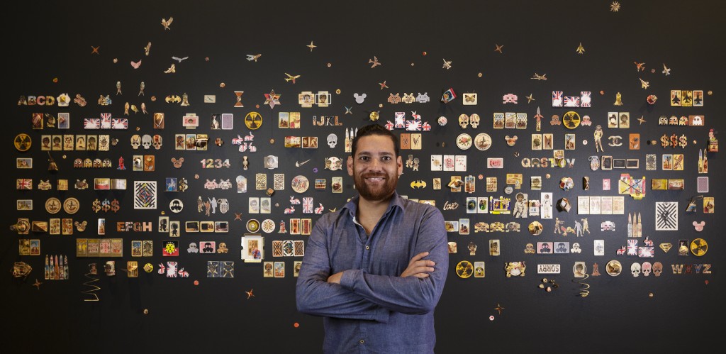Tony Albert with his winning work The Hand You're Dealt, 2015, vintage Aboriginal playing cards, dimensions variable. Represented by sullivan+strumpf, Sydney. Photograph by Sam Noonan, courtesy Anne & Gordon Samstag Museum of Art, University of South Australia. 