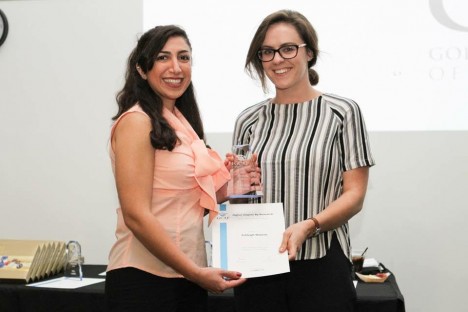 PhD candidate Ashleigh Watson accepts a Gold Coast Association of Postgraduates Research Award from GCAP Communications Director Gazelle Taherzadeh.