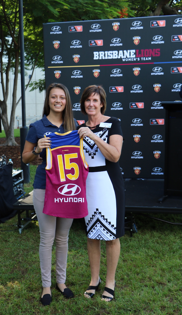 Bachelor of Exercise science student and Lions player Jade Ransfield is presented her jumper by Brisbane Lions Women's Foundation member Julie Perovic. (photo: Lions Media)