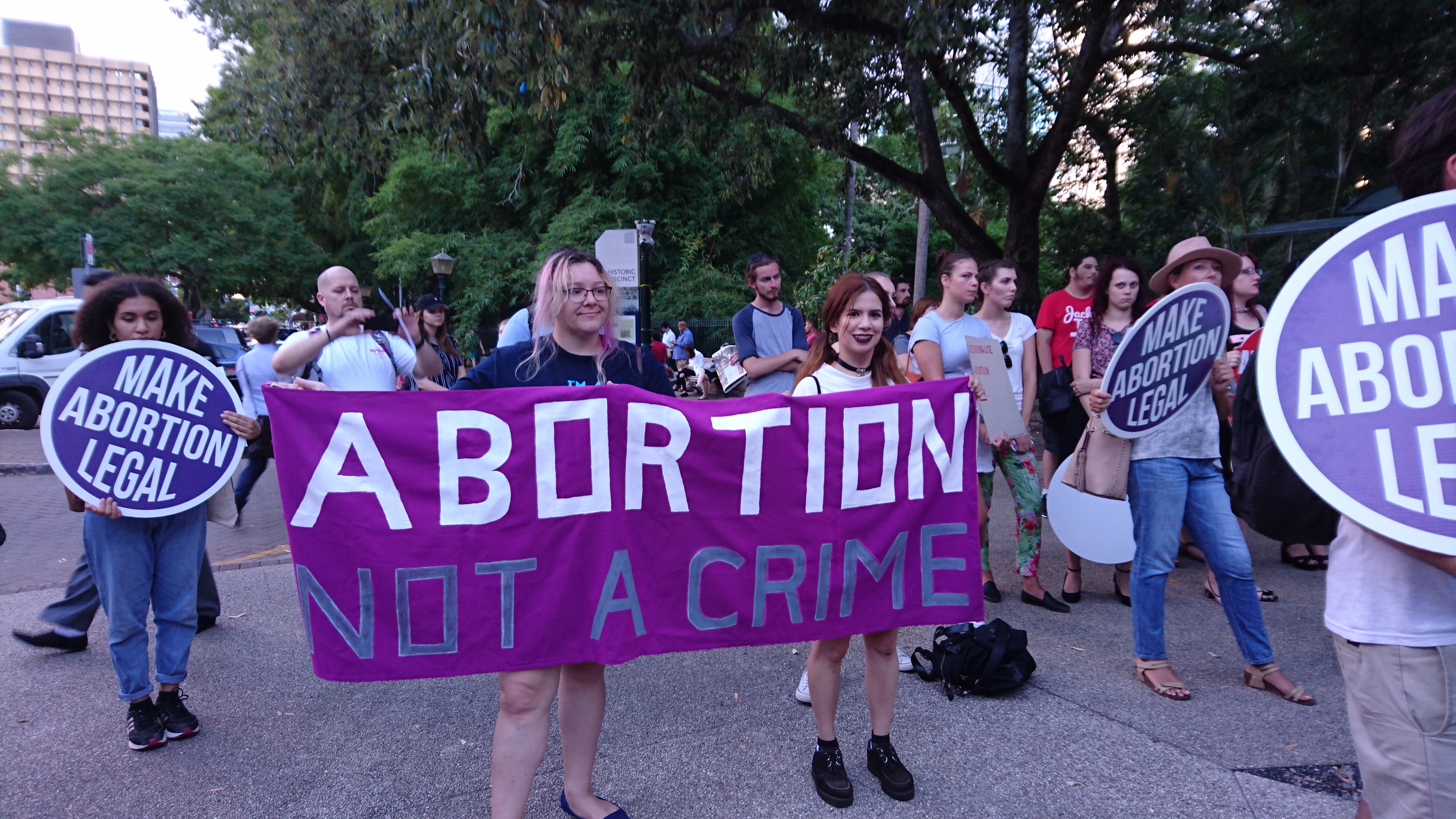 Young women holding sign at abortion rally