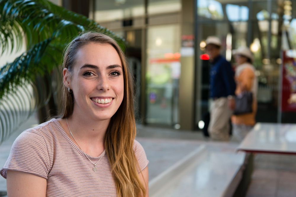 Scholarship recipient Lily Mitchell sitting on campus at Griffith University.