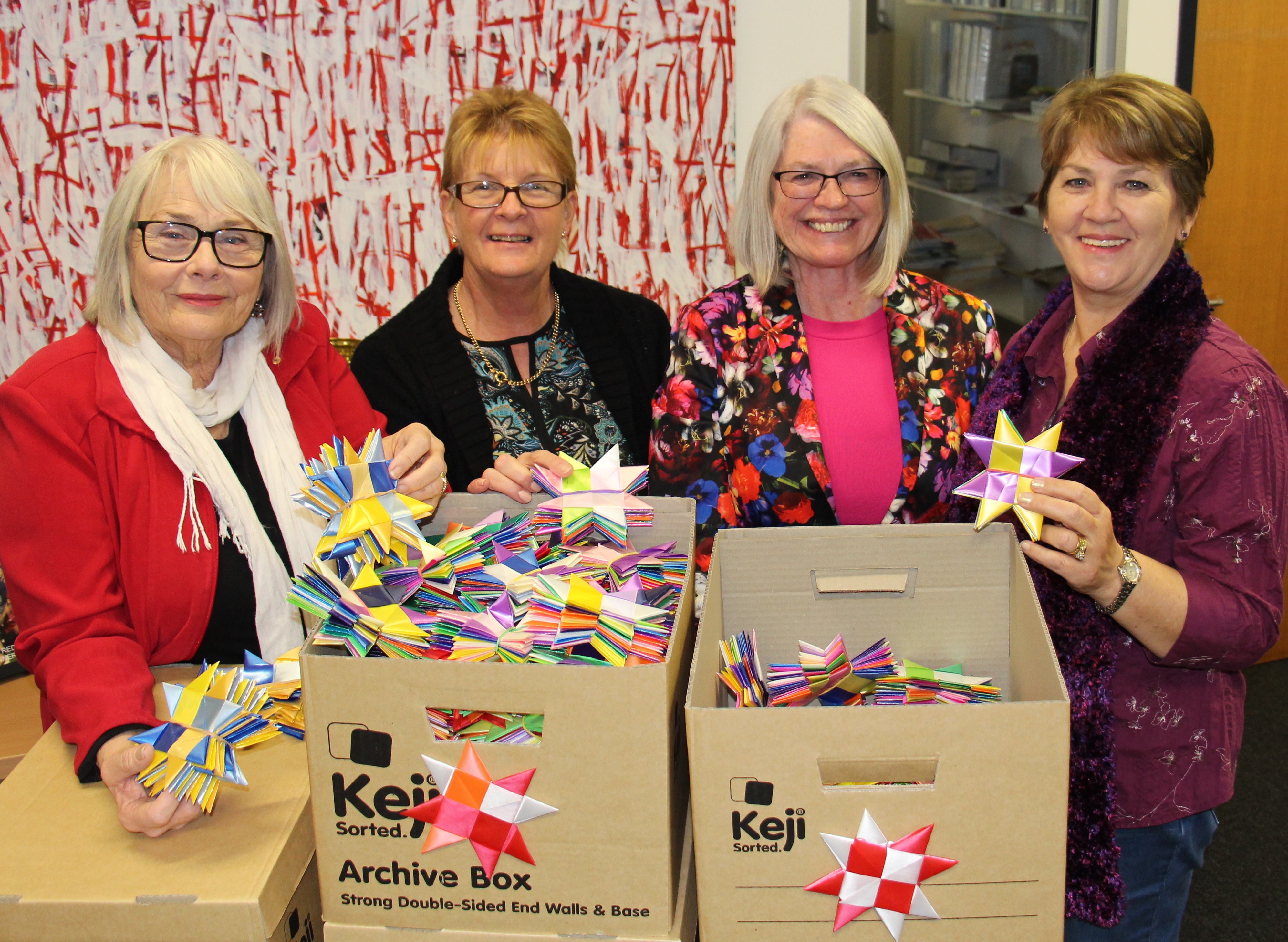 Professor Lesley Chenoweth AO, Heather Smith, Education and Professional Studies, Linda O'Brien, incoming Head of Logan campus and Ileana Whelan, Library and Learning Services, pack up Griffithâ€™s contribution to the 1 Million Stars project for delivery.