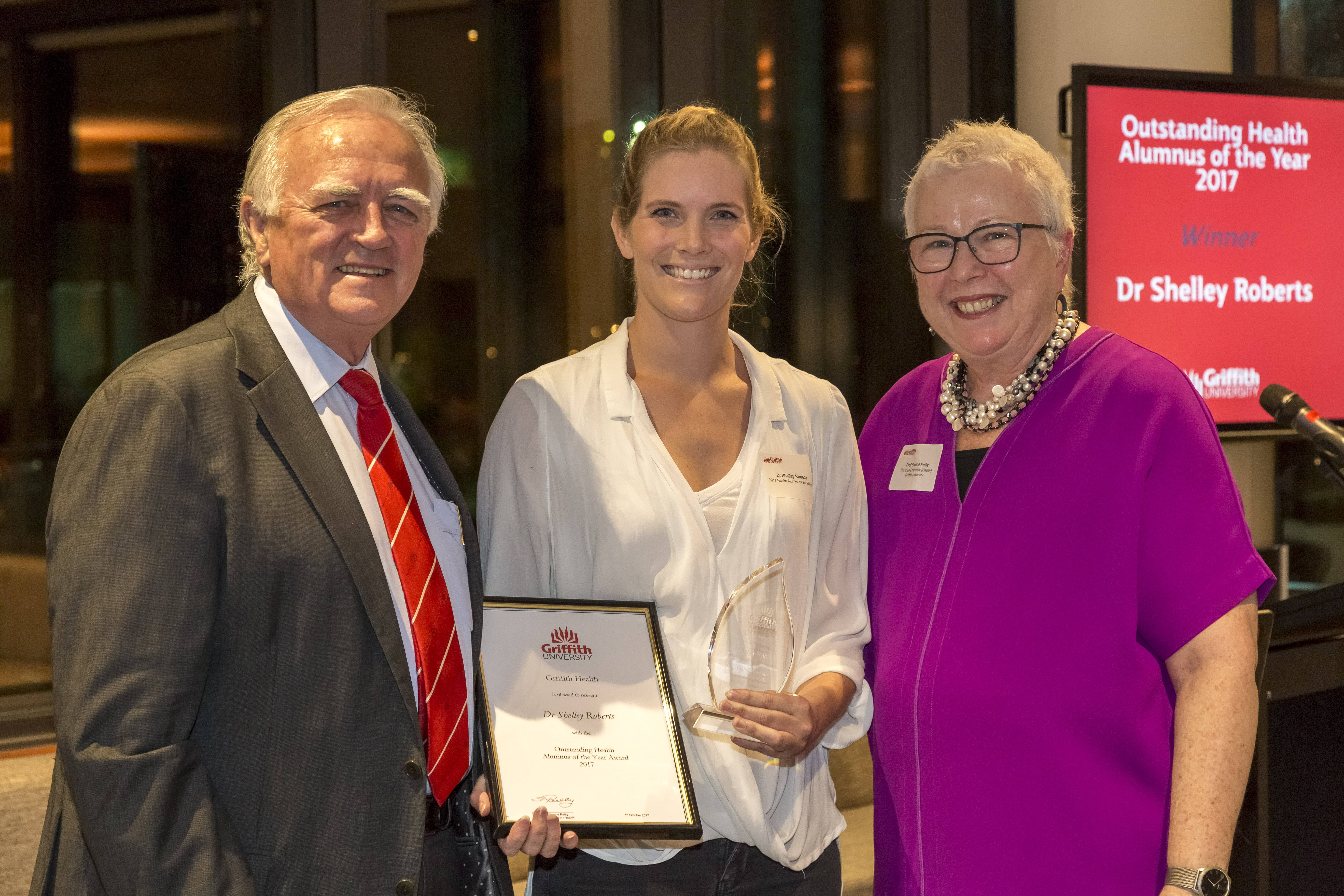 Three in a row: Griffith University Chancellor, Mr Henry Smerdon AM, with Outstanding Overall Health Alumnus of the Year, Dr Shelley Roberts, and Pro Vice Chancellor (Health) Professor Sheena Reilly