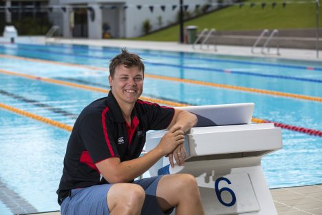 Chris Wright sits by a swimming pool