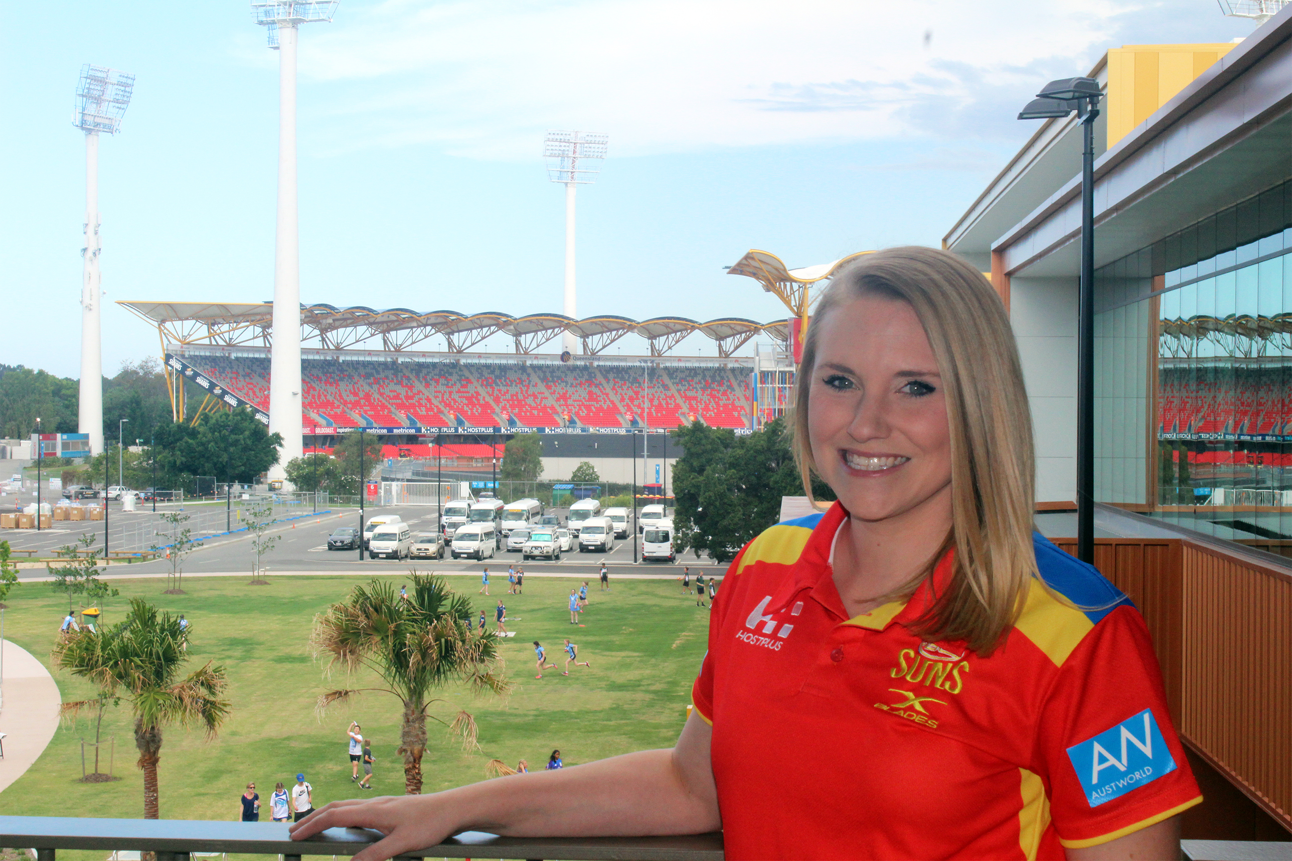 Business graduate Lia Ferguson, pictured looking over Metricon Stadium playing arena