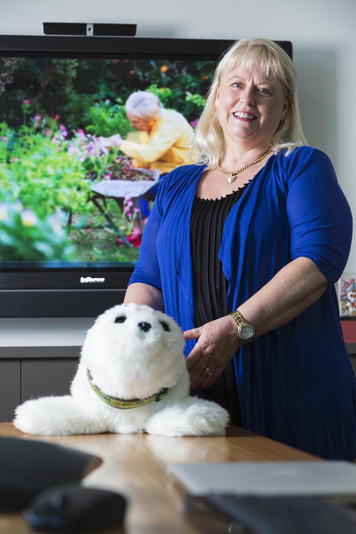 Professor Wendy Moyle with a PARO robot - one that looks and acts like a baby harp seal.