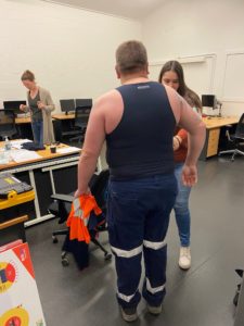 Truck driver being fitted with a biometric vest