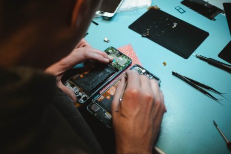 A person repairs a mobile phone