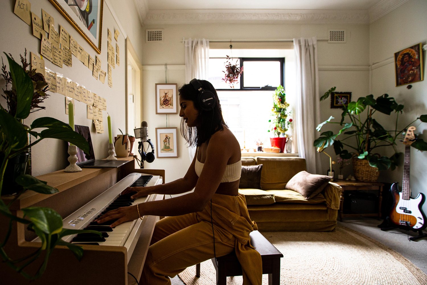 Vidya Makan playing the piano with headphones on