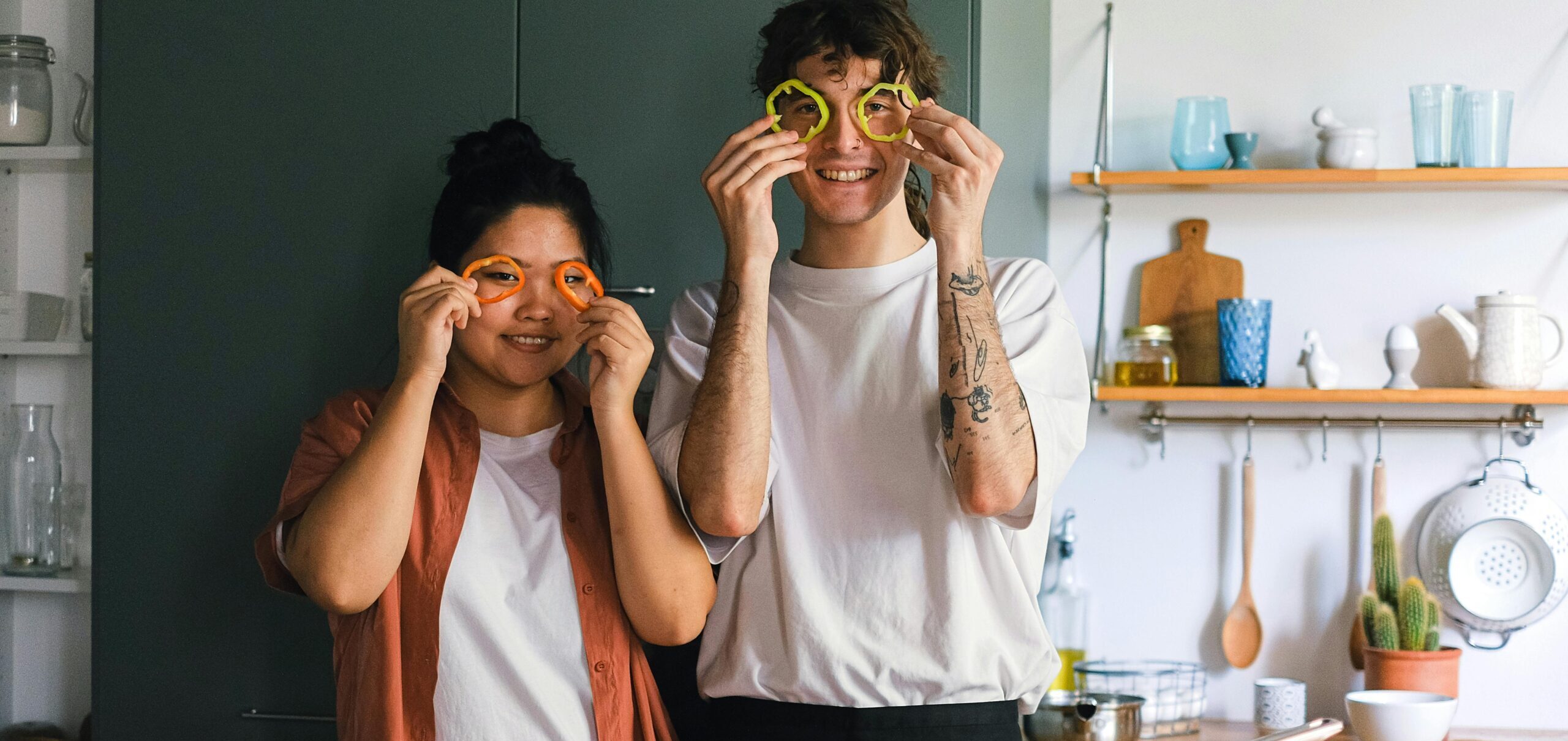 Two young people in the kitchen preparing vegetables