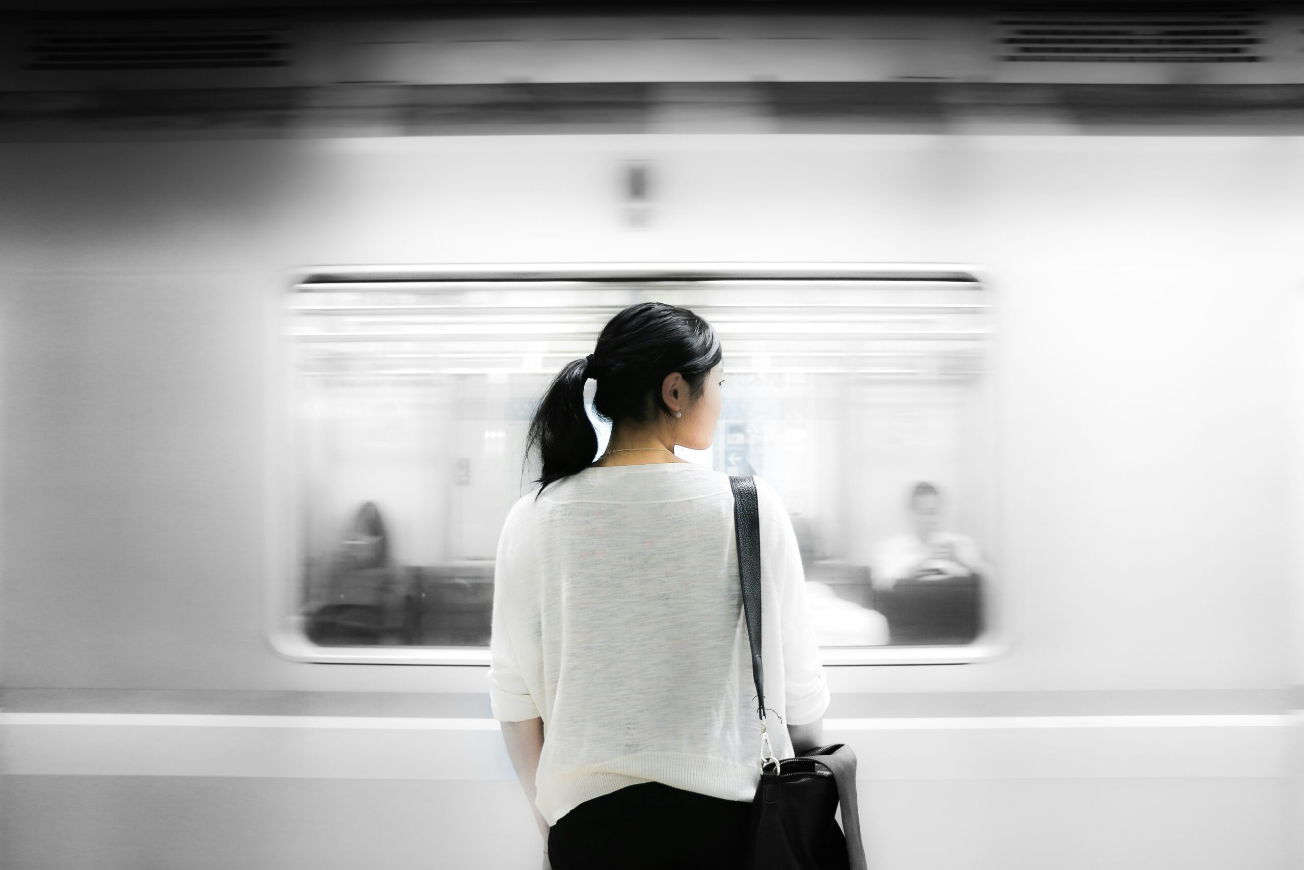 A woman standing at a train station