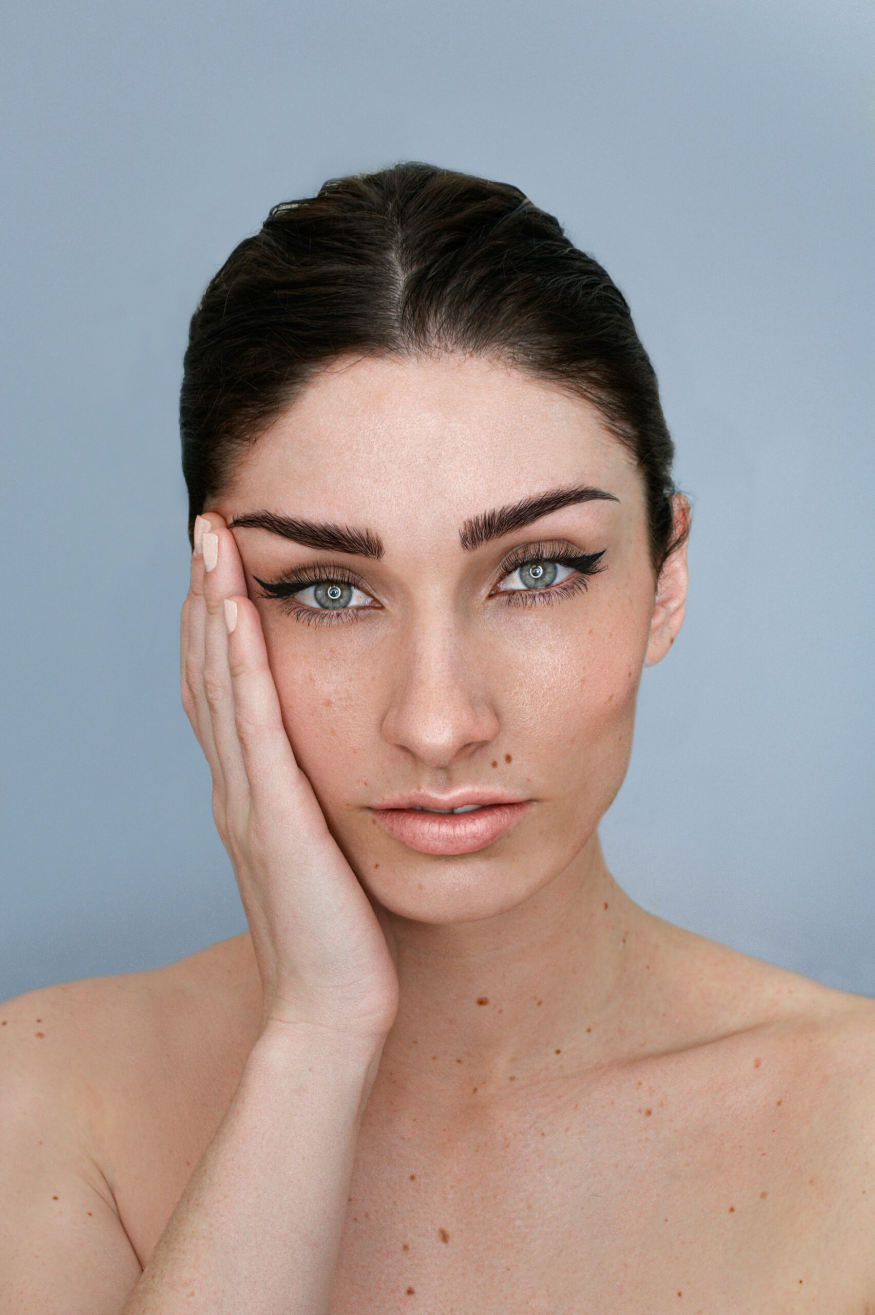 A young woman with her hand on her face